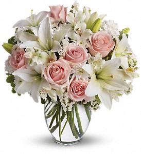 Roses and lily arranged in clear vase, available for same day delivery by local florist in Winnipeg-Valley Flowers