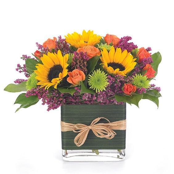 Sunflowers with bright and colorful flowers in glass vase for any occasion.