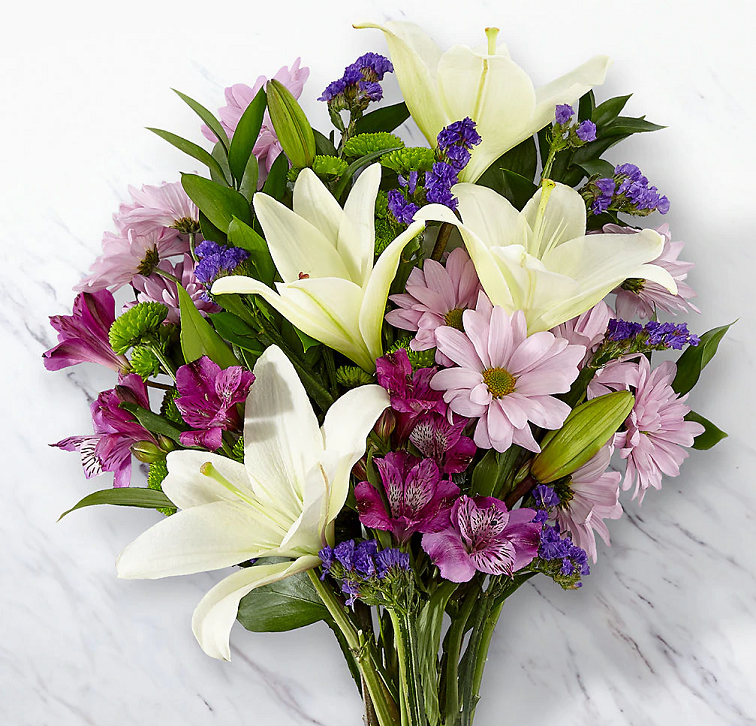 White lily with lavender daisy and purple flowers handtied and ready for delivery.