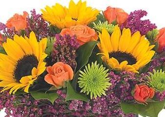 Sunflowers and roses in fall colors in this beautiful handtied bouquet