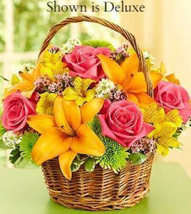 Orange, pink and yellow flowers arranged in Basket. Ready for delivery in Winnipeg 