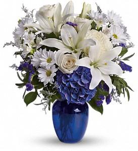 Beautiful blue flowers arranged in blue vase by Valley Flowers your Winnipeg florist.