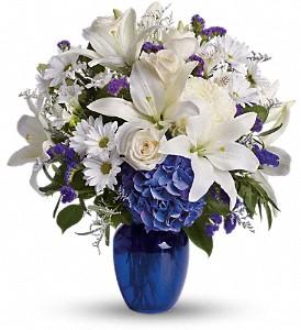 Blue and white flowers arranged in blue vase are the perfect choice to send for sympathy flowers in Winnipeg. 