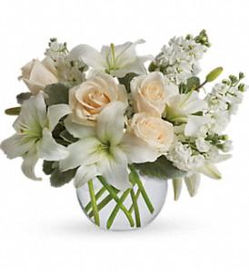 White flowers in clear vase  make a perfect gift for sympathy flowers. 
