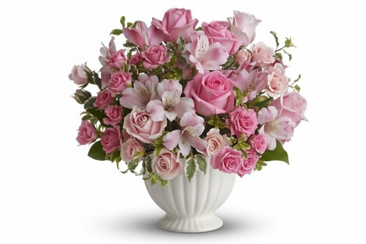 Pink flowers suitable for sympathy flowers, arranged in white container. 