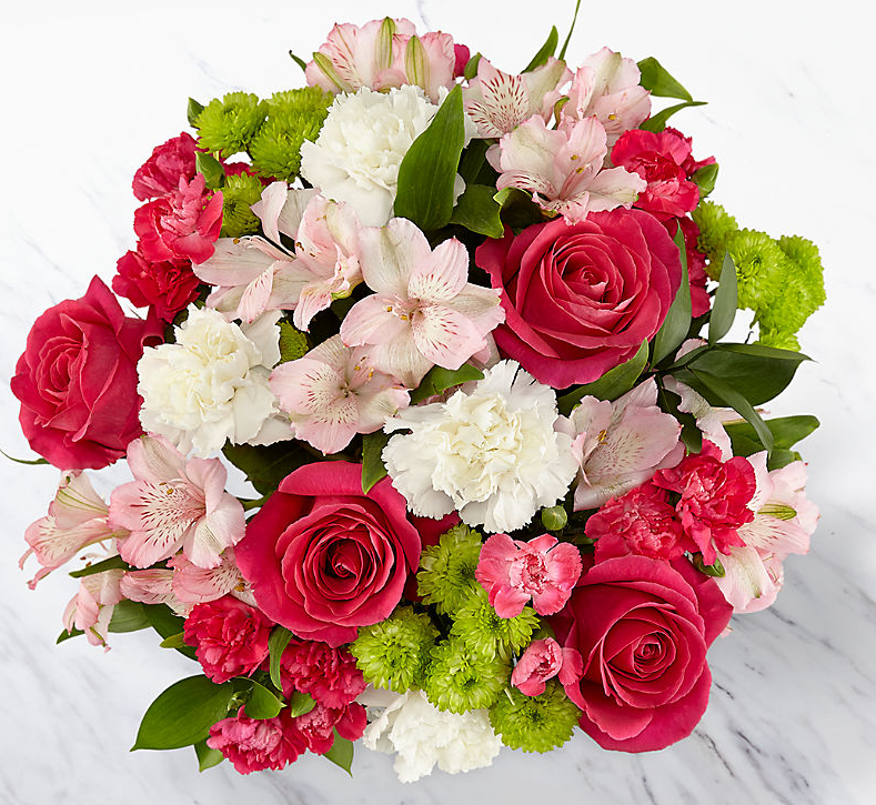 Roses and carnations make this a lovely flower gift for any occasion.