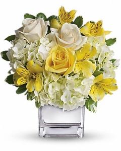 Touch of yellow among lovely white flowers make this a lovely gesture of your sympathy.
