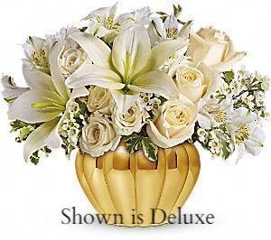 Soft white flowers perfect for sympathy flowers arranged in metallic container. 
