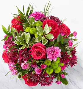 Garden style flowers in pink, purple and green with roses.